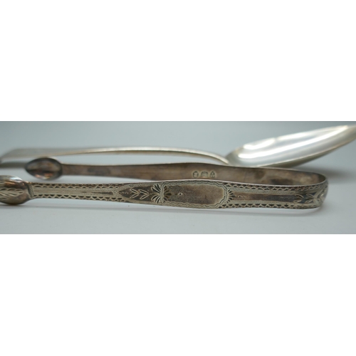 7242 - A George III silver serving spoon, London 1808, and a pair of Georgian silver sugar bows with monogr... 