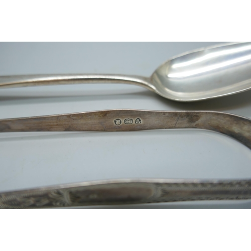 7242 - A George III silver serving spoon, London 1808, and a pair of Georgian silver sugar bows with monogr... 