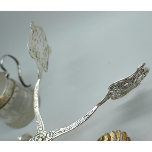 7243 - A collection of silver and white metal - a silver swizzle stick, silver mounted glass, a silver napk... 