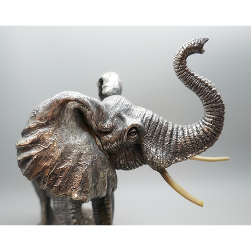 7251 - A hallmarked silver 'filled' model of an elephant, faux ivory tusks, 18.5cm tall