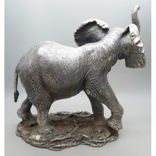 7251 - A hallmarked silver 'filled' model of an elephant, faux ivory tusks, 18.5cm tall