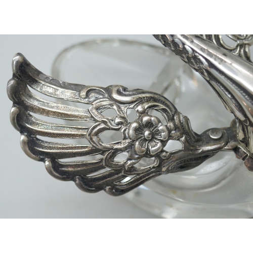 7260 - A pair of silver and glass swan salts, stamped 925, together with two silver salt spoons with cherub... 