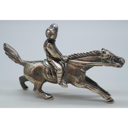 7262 - A small model of a horse and jockey, 7 x 4.5cm