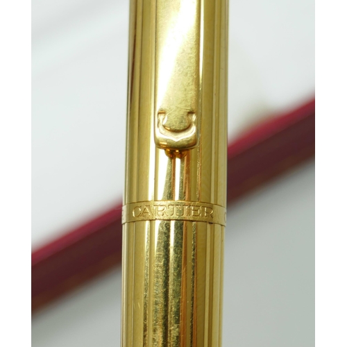 7267 - A Cartier gold plated fountain pen with 18k gold nib, serial number 024374, boxed with 2 leaflets