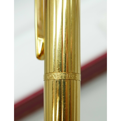 7267 - A Cartier gold plated fountain pen with 18k gold nib, serial number 024374, boxed with 2 leaflets