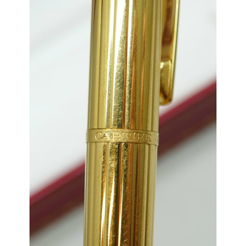 7267 - A Cartier gold plated fountain pen with 18k gold nib, serial number 024374, boxed with 2 leaflets