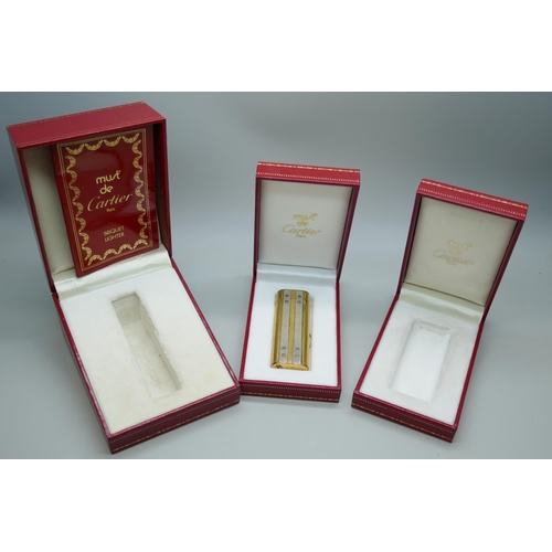 7268 - A Must De Cartier gold plated lighter, boxed, together with two empty Cartier boxes