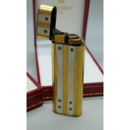 7268 - A Must De Cartier gold plated lighter, boxed, together with two empty Cartier boxes