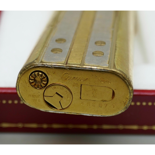 7268 - A Must De Cartier gold plated lighter, boxed, together with two empty Cartier boxes