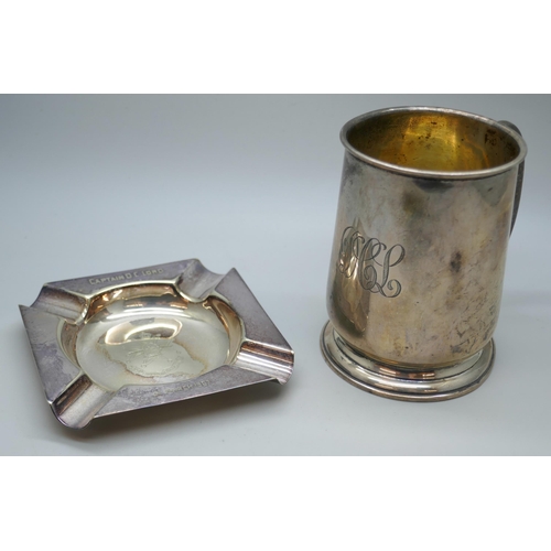 7269 - A silver mug with engraved monogram, Birmingham 1931, 114g, 8.5cm, together with a silver plated ash... 