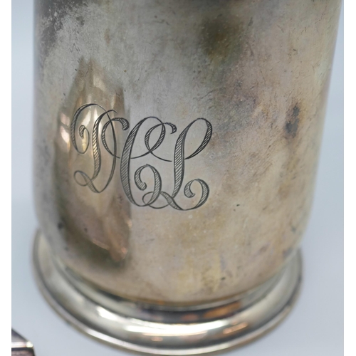 7269 - A silver mug with engraved monogram, Birmingham 1931, 114g, 8.5cm, together with a silver plated ash... 