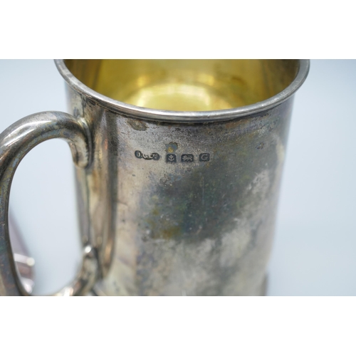 7269 - A silver mug with engraved monogram, Birmingham 1931, 114g, 8.5cm, together with a silver plated ash... 