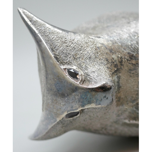 7270 - A silver stylised model of a bull, set with garnet eyes, London 1962, 322g