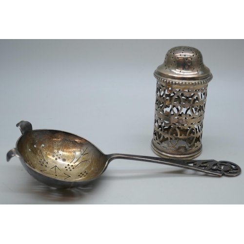 7273 - A silver tea strainer with fretwork handle, 43g, together with a silver shaker lacking liner, 43g