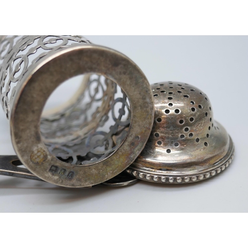 7273 - A silver tea strainer with fretwork handle, 43g, together with a silver shaker lacking liner, 43g