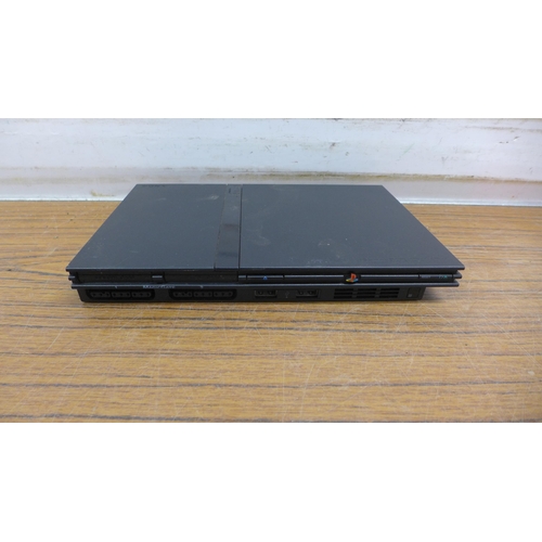 5088 - A PlayStation 2 slim with 4 games - no cables or controllers