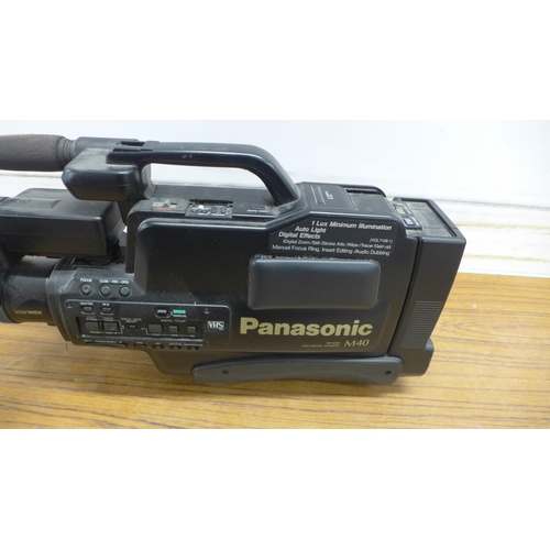 5092 - A Panasonic M40 VHS NV-M40 HQ movie camera with tripod on casters