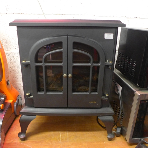 5107 - A Warm-lite WL46001 electric fireplace heater and a metal fireplace companion set