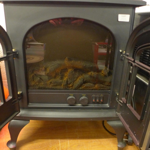 5107 - A Warm-lite WL46001 electric fireplace heater and a metal fireplace companion set