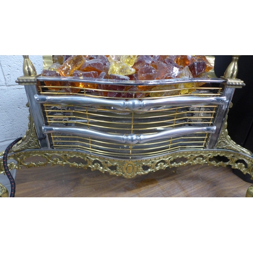 5113 - An Imperial Electric Co. Ltd. brass fire surround electric heater with coloured glass coals