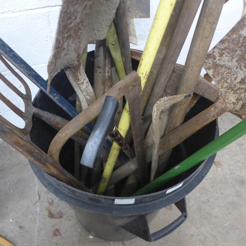 5169 - A large quantity of assorted garden tools including spades, forks, rake, shears, hoes, bow saw, pick... 