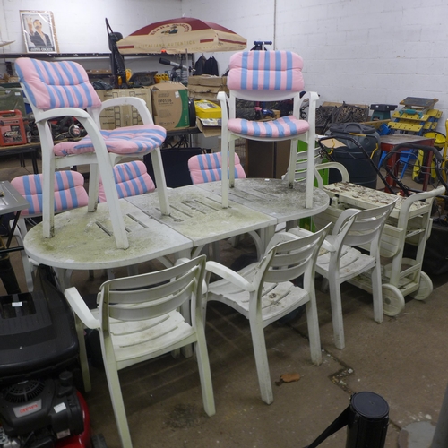 5175 - A white plastic extending garden table with 8 chairs, sun lounger and side trolley table