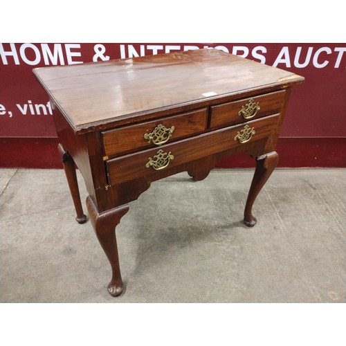 173 - A George III mahogany three drawer lowboy