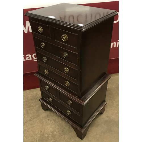 197 - A small George III style inlaid mahogany chest on chest