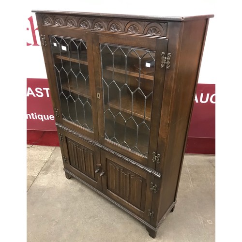 199 - A carved oak linenfold four door bookcase