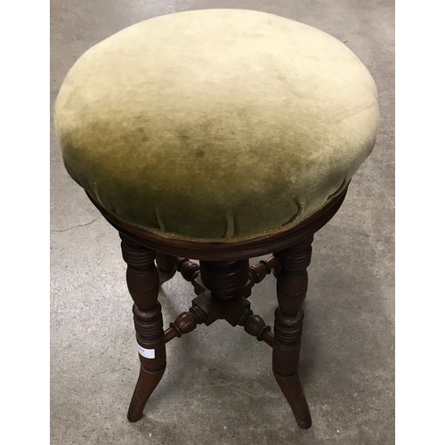 202 - A Victorian mahogany revolving piano stool