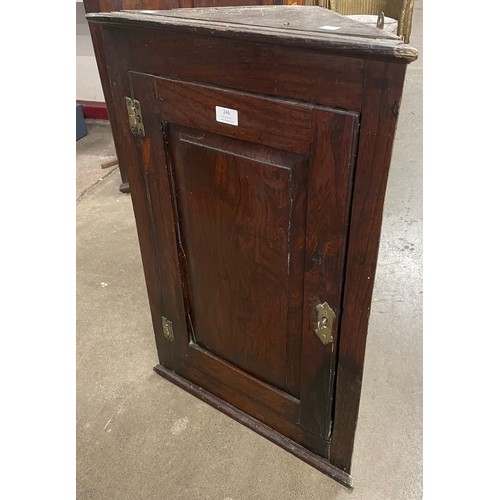 246 - A George III oak splay front wall hanging corner cupboard