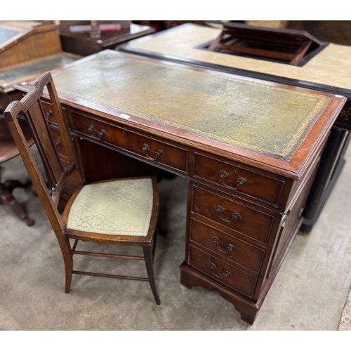 225 - A mahogany and green leather topped pedestal desk and an inlaid mahogany hall chair