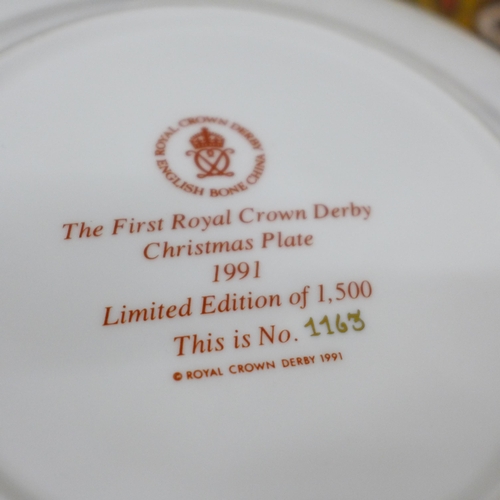 2060 - A Royal Crown Derby 1128 limited edition Christmas plate, boxed with certificate, a pair of Royal Cr... 