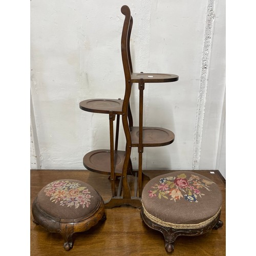 257 - Two Victorian carved walnut footstools and a mahogany folding cakestand