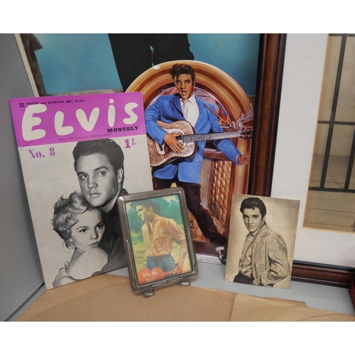 2102 - A collection of Elvis memorabilia and collectables, includes clip-on earrings, 78 rpm singles, frame... 