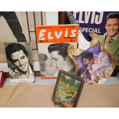 2102 - A collection of Elvis memorabilia and collectables, includes clip-on earrings, 78 rpm singles, frame... 