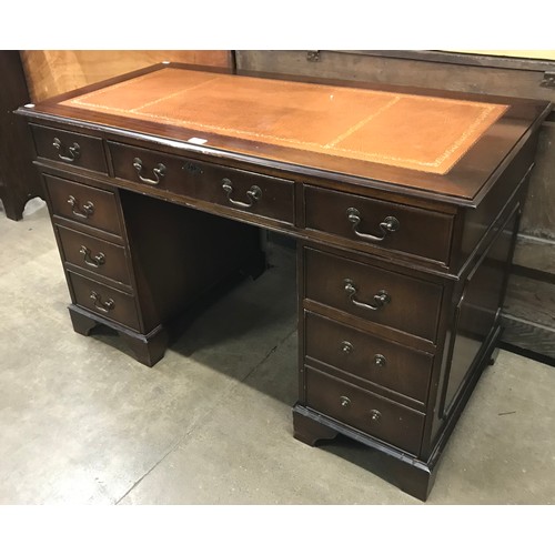 212 - A mahogany and tan leather topped pedestal desk