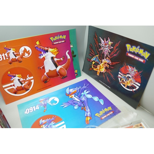 2182 - A Pokémon collectors tin chest with quantity of Holographic cards and mini binder, etc.