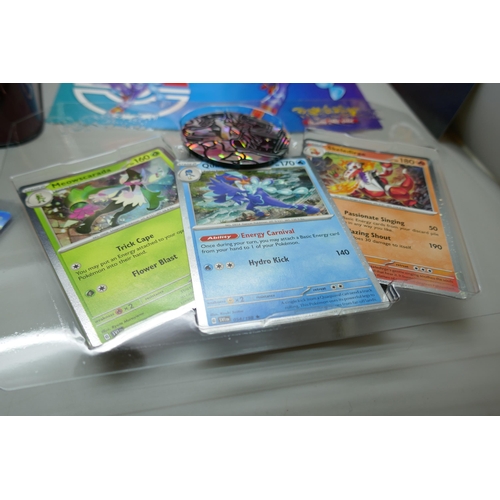 2182 - A Pokémon collectors tin chest with quantity of Holographic cards and mini binder, etc.