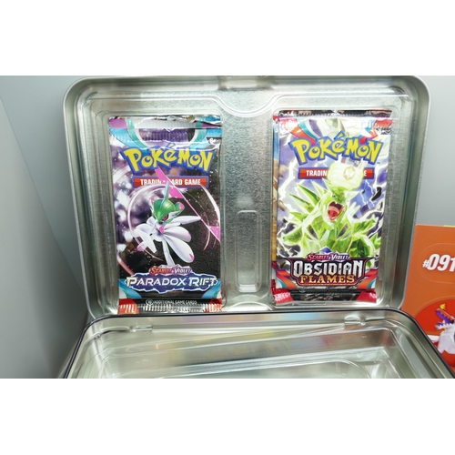 2182 - A Pokémon collectors tin chest with quantity of Holographic cards and mini binder, etc.