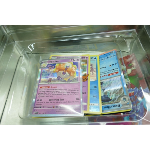 2182 - A Pokémon collectors tin chest with quantity of Holographic cards and mini binder, etc.