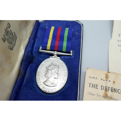 2185 - A Civil Defence Long Service Medal, M. Cowpe, and two WWII Defence Medal compliment slips