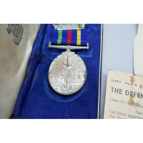 2185 - A Civil Defence Long Service Medal, M. Cowpe, and two WWII Defence Medal compliment slips