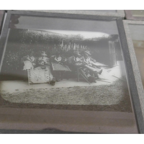 2204 - A box of 44 Victorian and Edwardian lantern slides, includes beach scenes, street scenes, motor car ... 