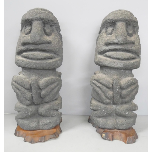 2211 - Two Easter Island bookends and an Inuit carved stone figure of a stylised polar bear devouring a sea... 