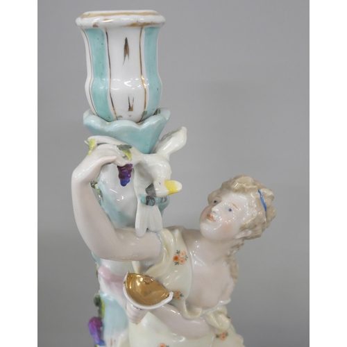 2216 - A German porcelain figural candlestick with floral relief detailing to base