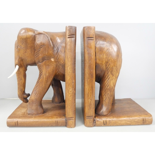 2225 - A pair of wooden elephant book ends with a wooden Buddha figure sat in the lotus position and a bron... 