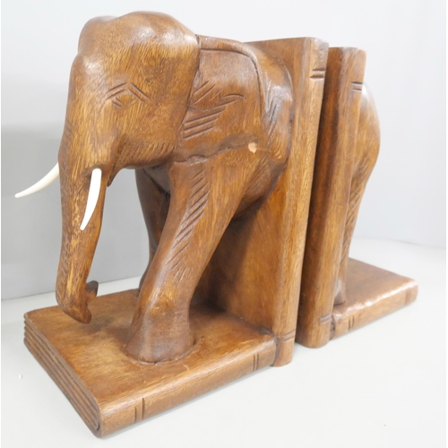 2225 - A pair of wooden elephant book ends with a wooden Buddha figure sat in the lotus position and a bron... 