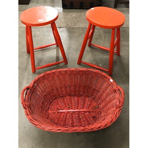 262 - A pair of red painted kitchen stools and a wicker basket