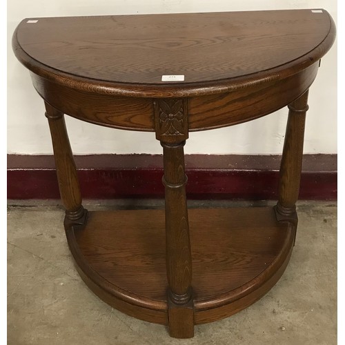 273 - An oak demi lune hall table